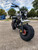 TM Hurricane 200X Upgraded Mini Bike, front view of a durable mini motorcycle with large off-road tires, black frame, and headlight, suitable for outdoor riding and off-road adventures.