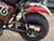 TM Hurricane 200X Upgraded Mini Bike, close-up view of the rear wheel, suspension, and fender with red and black design.