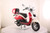 TM Sorento 200A Scooter Moped, a red and white vintage style scooter with a large windshield, side mirror, and rear storage box, displayed on a white platform.