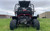 TM 300 XRS-4E 4 Seater Go Kart for Families, front view of the off-road go-kart in a grassy field with buildings and cloudy sky in the background.