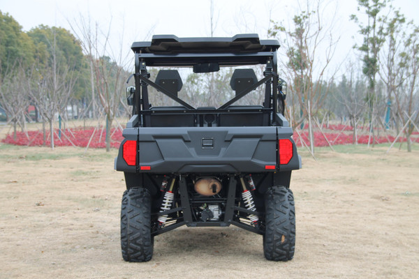 TM Panther 550 Side by Side UTV, front view of a rugged off-road utility vehicle with large tires and rear cargo bed parked in an open field.