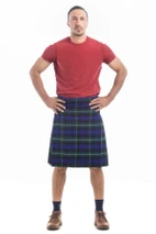 Man wearing a bespoke kilt in yellow and black tartan with a red t-shirt, front view