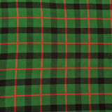 Close-up of bespoke kilt fabric in green and blue tartan with red lines