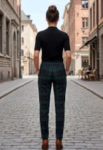 Slim cut tartan trousers in dark green and navy, back view on a woman