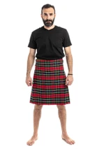 Man wearing a bespoke kilt in black and dark navy tartan with front apron pocket, front view