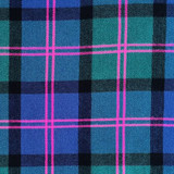 Close-up of red tartan fabric with dark green and blue checks for a bespoke kilt