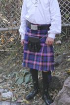 Purple and blue tartan kilt with black sporran on chain and belt, waist-down view