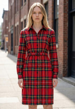 Plaid button-front shirt dress in red tartan with belt, worn by a woman outdoors