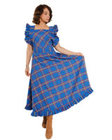 Woman holding out the skirt of blue tartan ruffled maxi dress