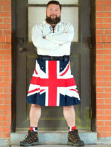 Man with arms crossed in Union Jack flag kilt standing in a doorway