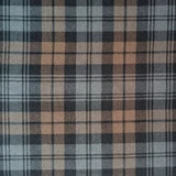 Close-up of navy and green tartan fabric with red and white lines for a bespoke kilt