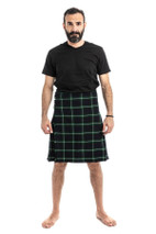 Man in navy and green tartan trousers with a green T-shirt, back view