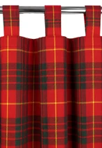 Red tartan tab top curtains with green and yellow lines hanging on a metal rod