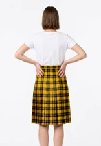 Back view of woman in yellow and black tartan full pleat skirt