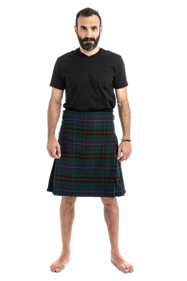 Man wearing a bespoke kilt in yellow, red and green tartan with a black t-shirt, front view