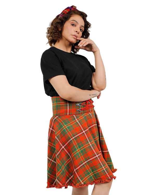 Woman in orange and green lace-up plaid skirt with black T-shirt