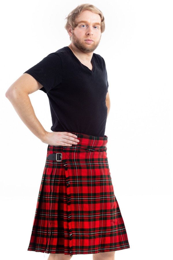 Three-quarter view of man in red tartan kilt with black T-shirt, hand on hip