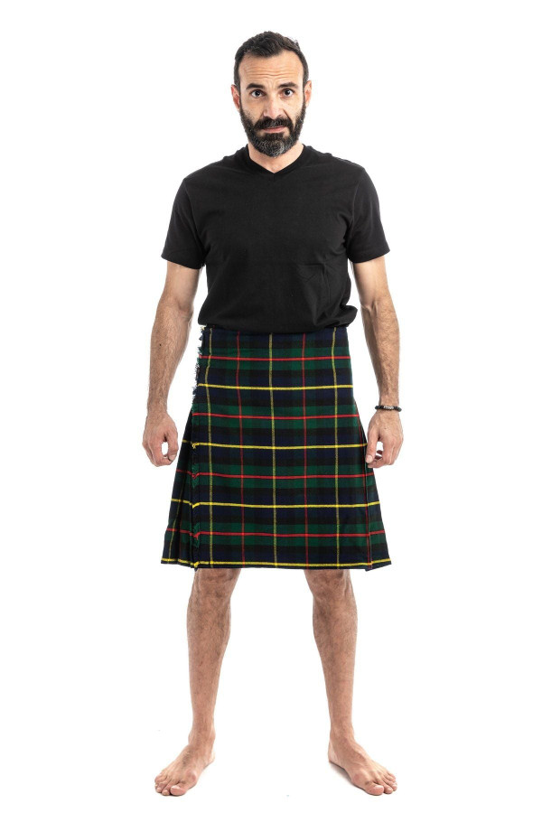 Man in navy and green tartan trousers with a green T-shirt, back view