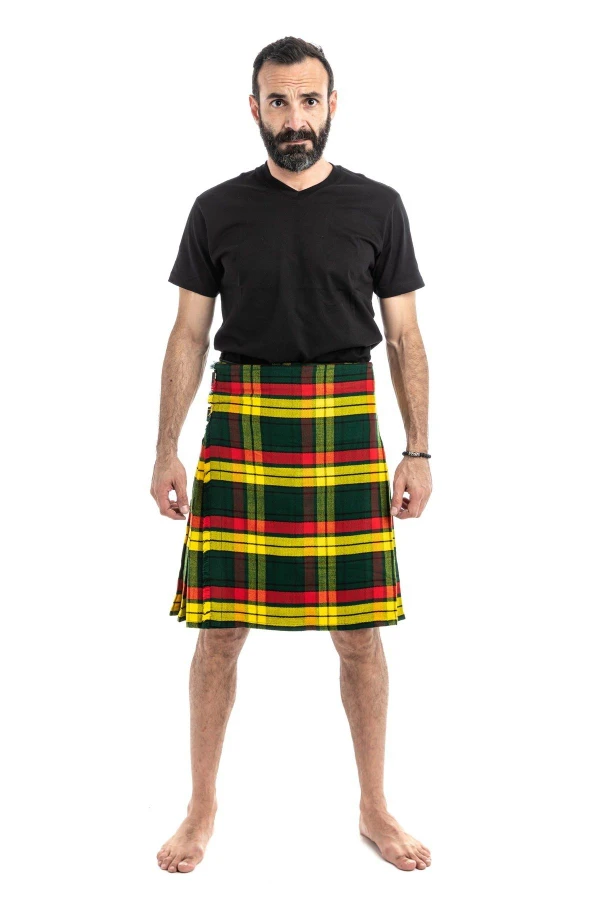 Man wearing a bespoke kilt in yellow, red and green tartan with a black t-shirt, front view