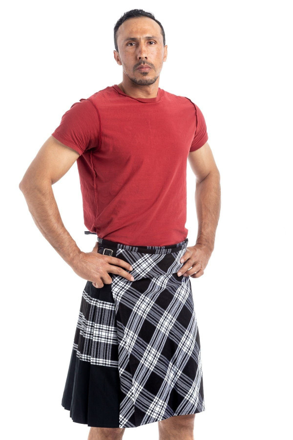 Man in black and white tartan hybrid kilt with black side panels, front view