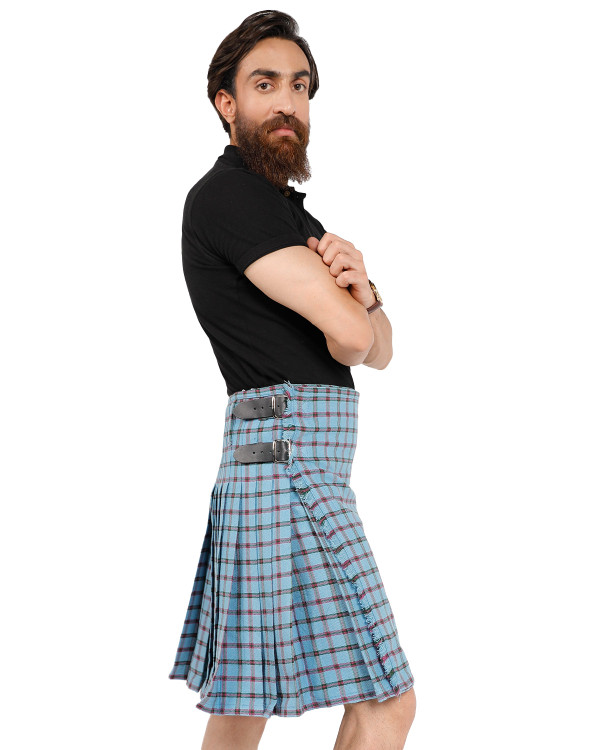Bespoke kilt in grey, white and blue tartan with leather straps, side view on a man