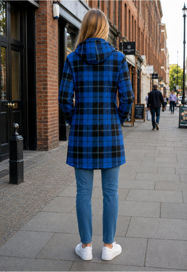 Woman in a blue and black plaid hoodie dress, back view on a city street