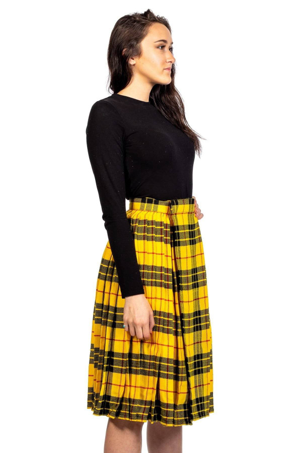 Woman in yellow and black tartan pleated midi skirt, side view