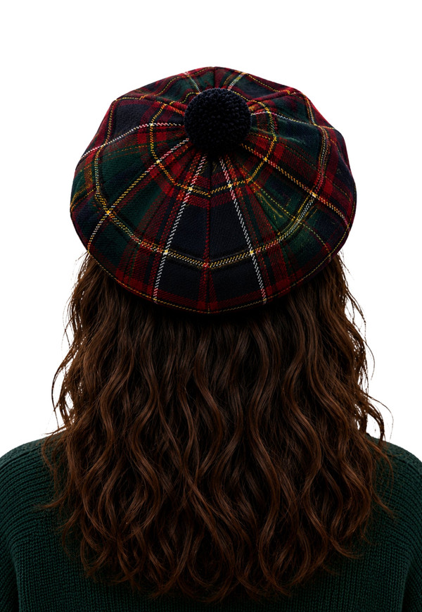 Tartan tam in dark green and red plaid with navy pom-pom, back view on a woman