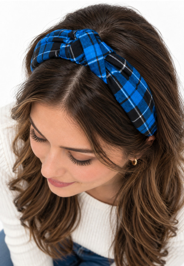 Woman wearing blue and black tartan twisted headband with top knot