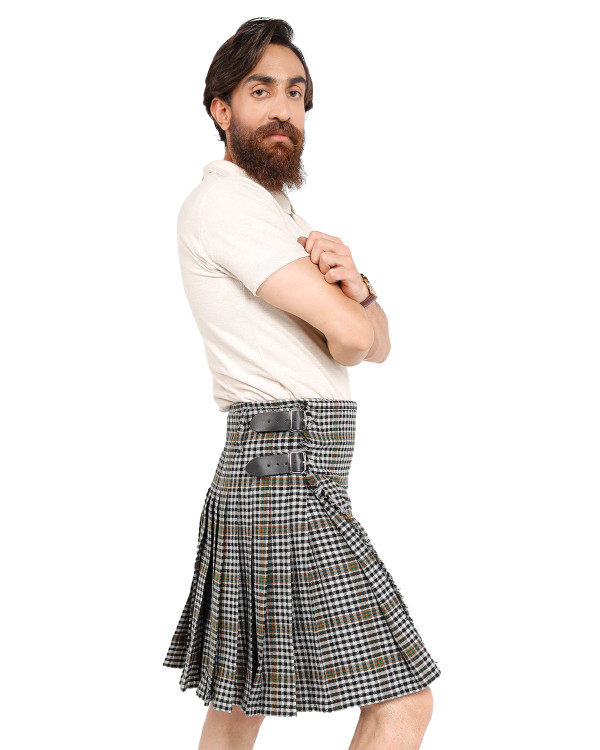 Man wearing a bespoke kilt in grey, black and white tartan, side view with arms crossed