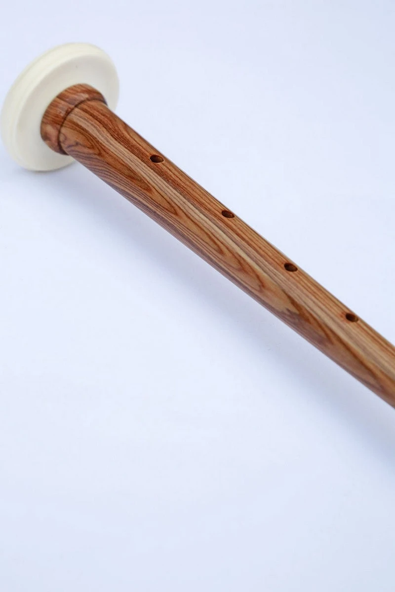 Close-up of wooden practice chanter top with white mouthpiece cap
