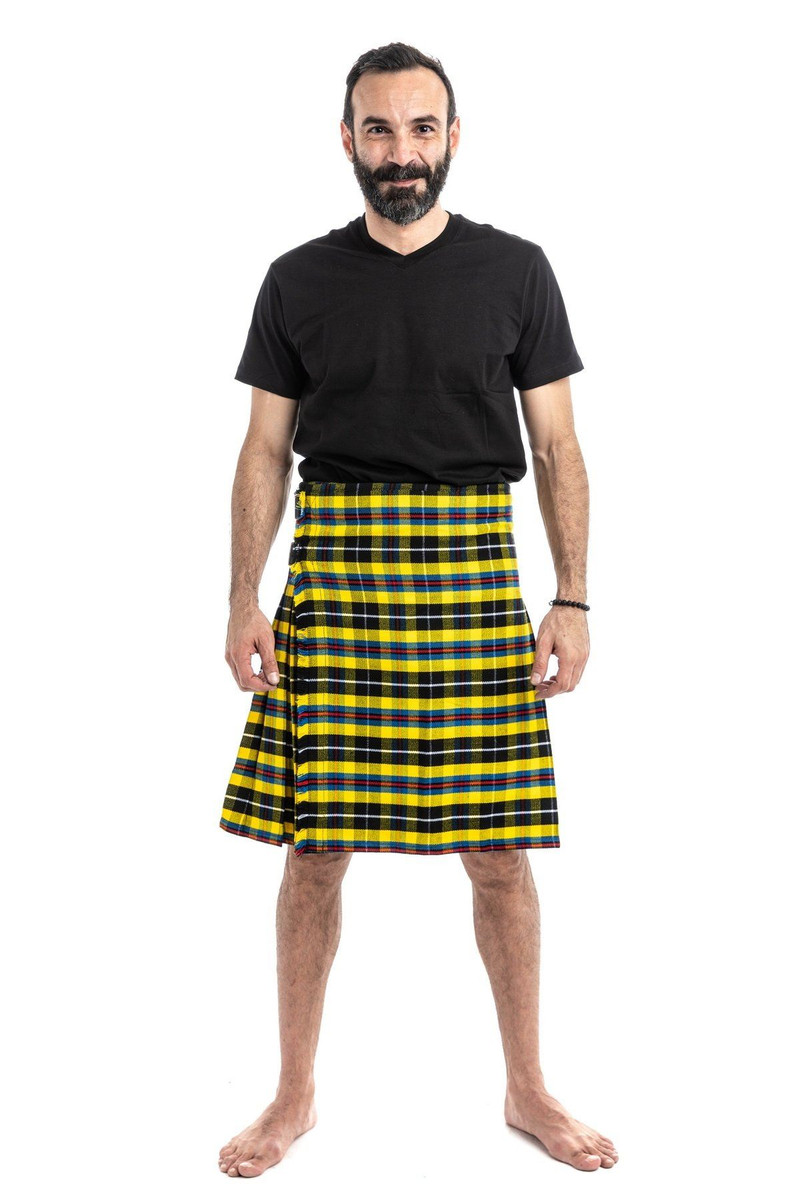 Front view of man in yellow and black tartan kilt with black T-shirt