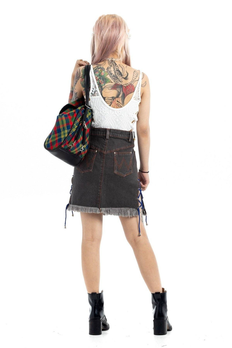 Back view of woman in black denim skirt with frayed hem