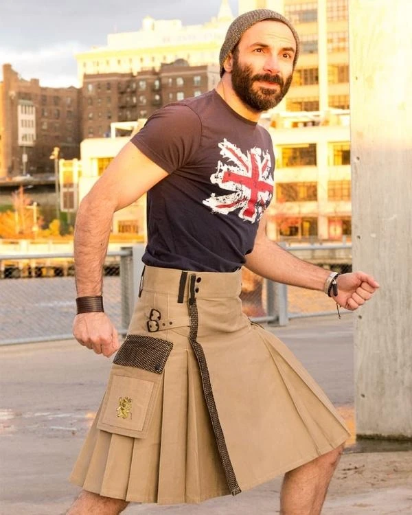 Man in khaki Elite Pro utility kilt with mesh pockets, posing outdoors