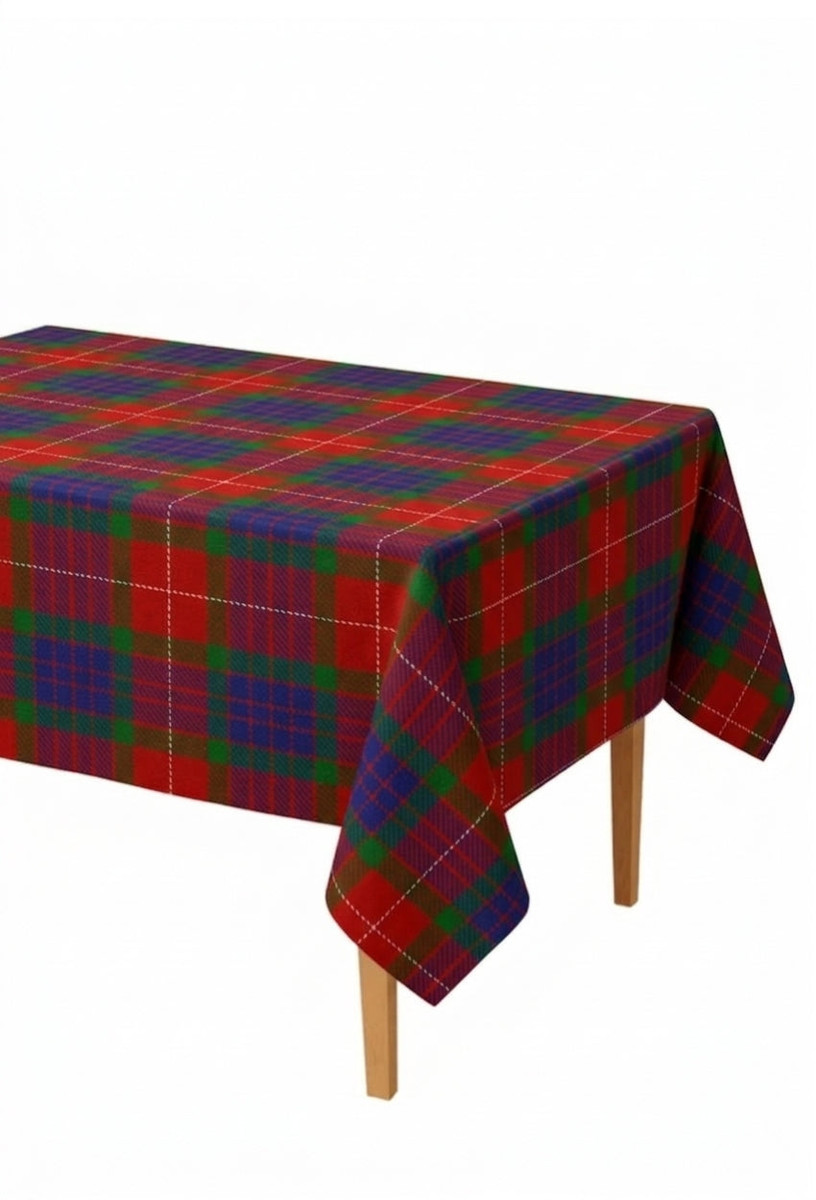 Rectangular tartan tablecloth in red, green and yellow plaid draped over a table