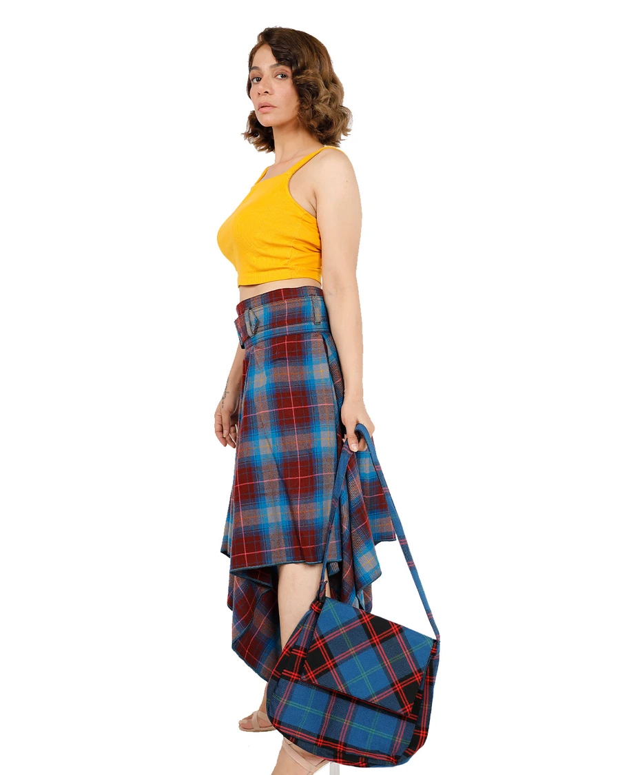 Woman in blue and red tartan Highland Breeze layered skirt with matching bag