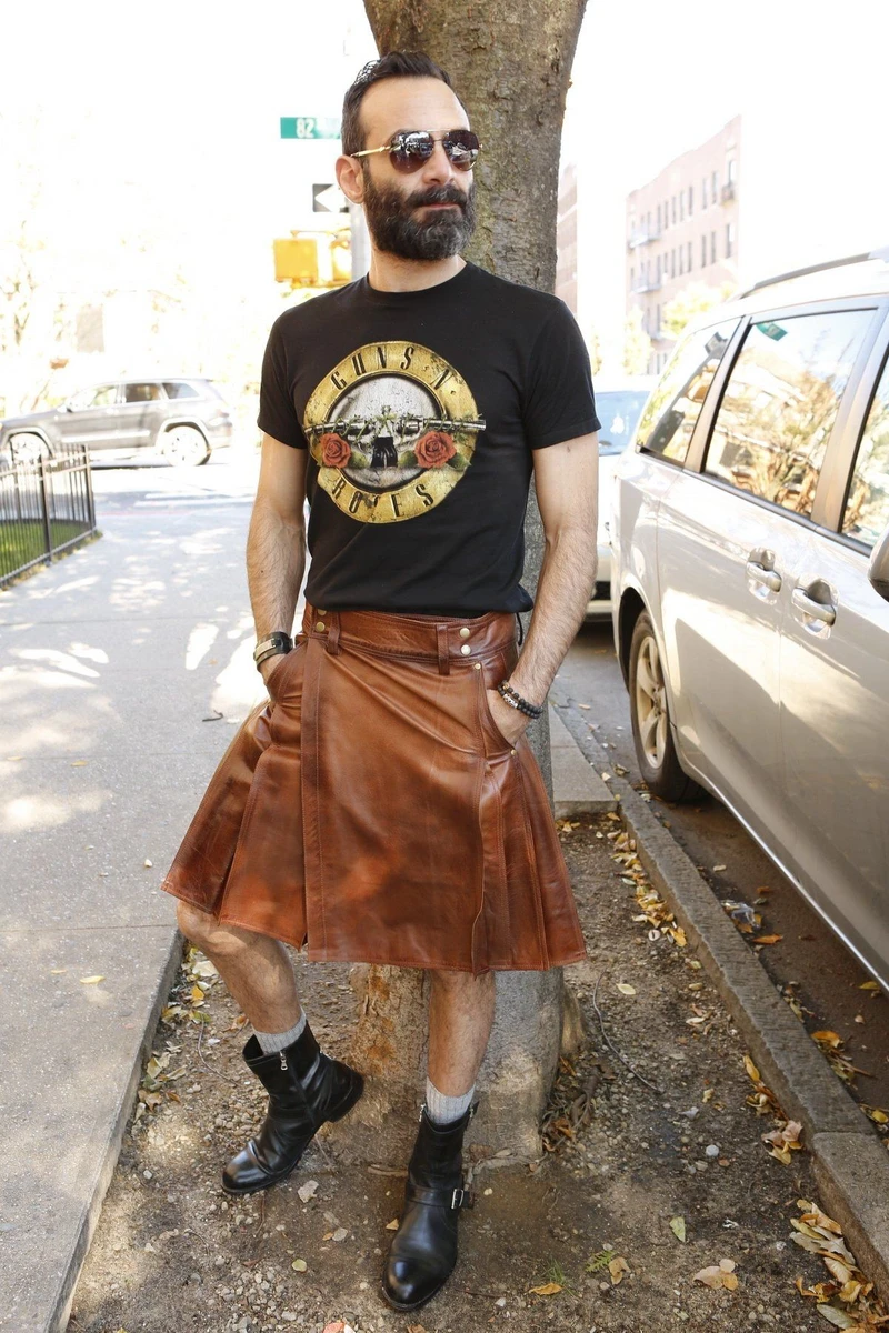 Front view of brown Ironclad leather kilt with black T-shirt on a city street