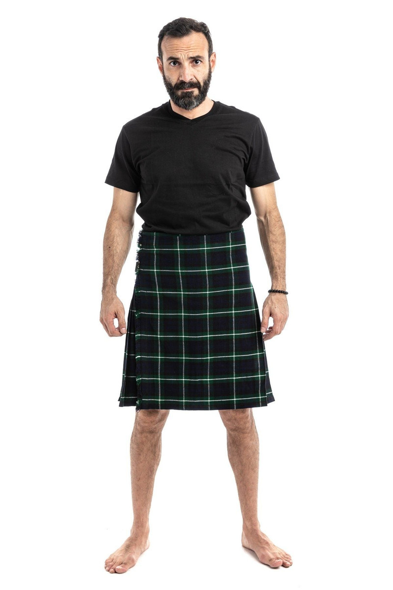 Man wearing a bespoke kilt in yellow, red and green tartan with a black t-shirt, front view