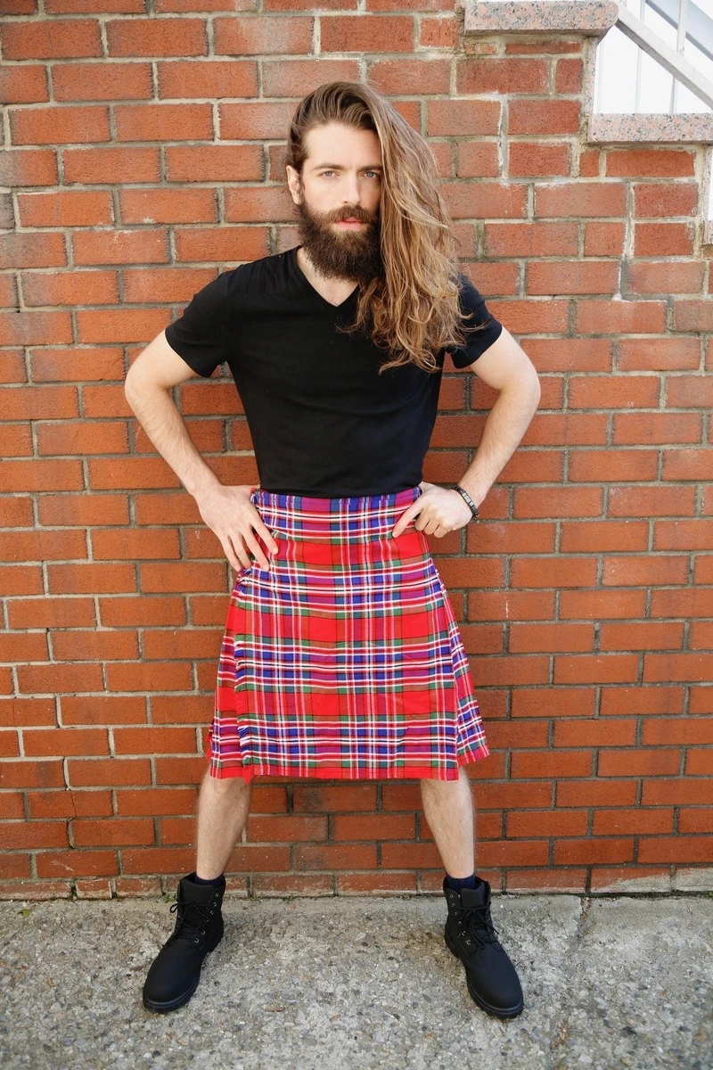Man in MacFarlane bespoke kilt in red and purple tartan by brick wall