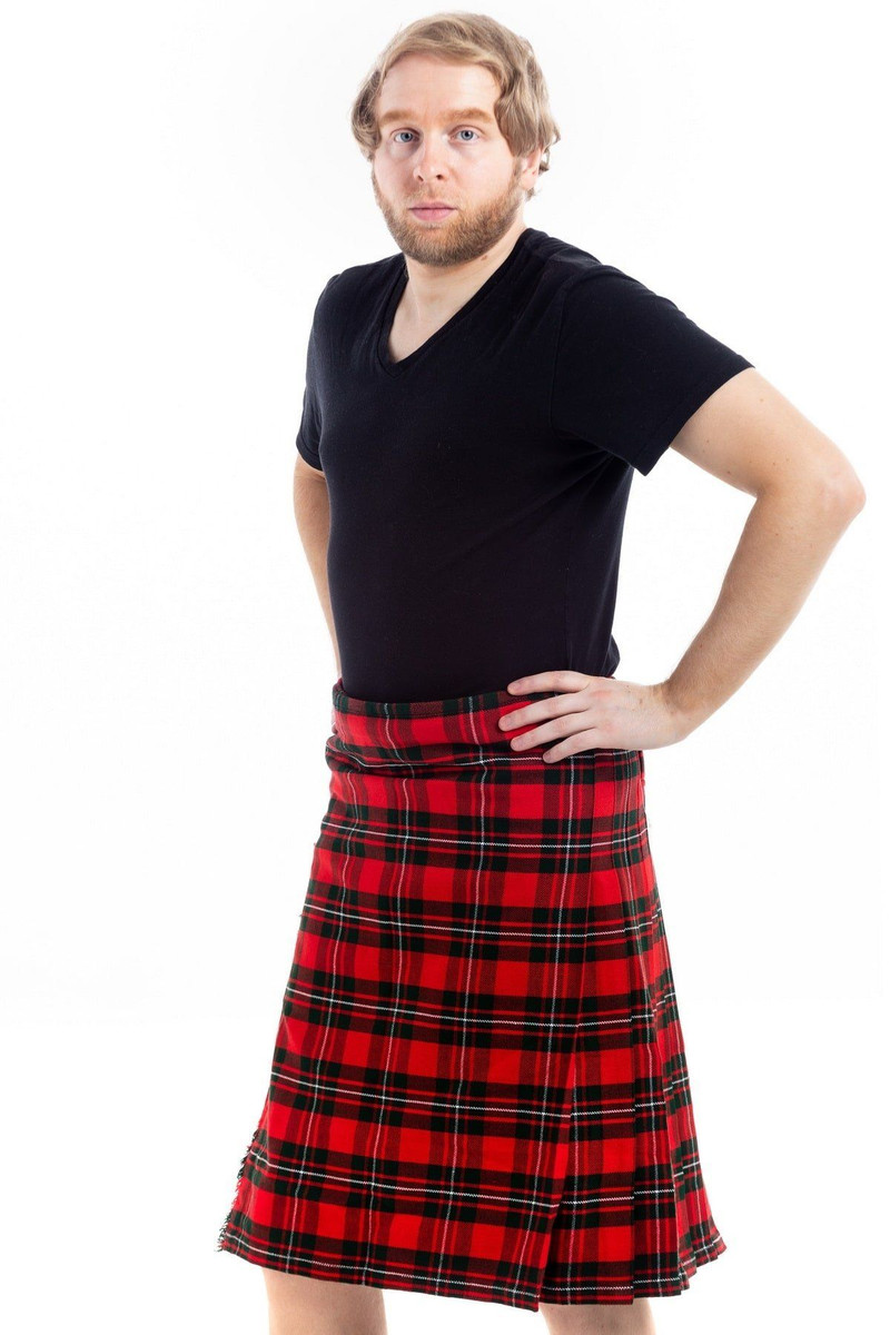Man wearing a bespoke kilt in red and black tartan, side view with hand on hip