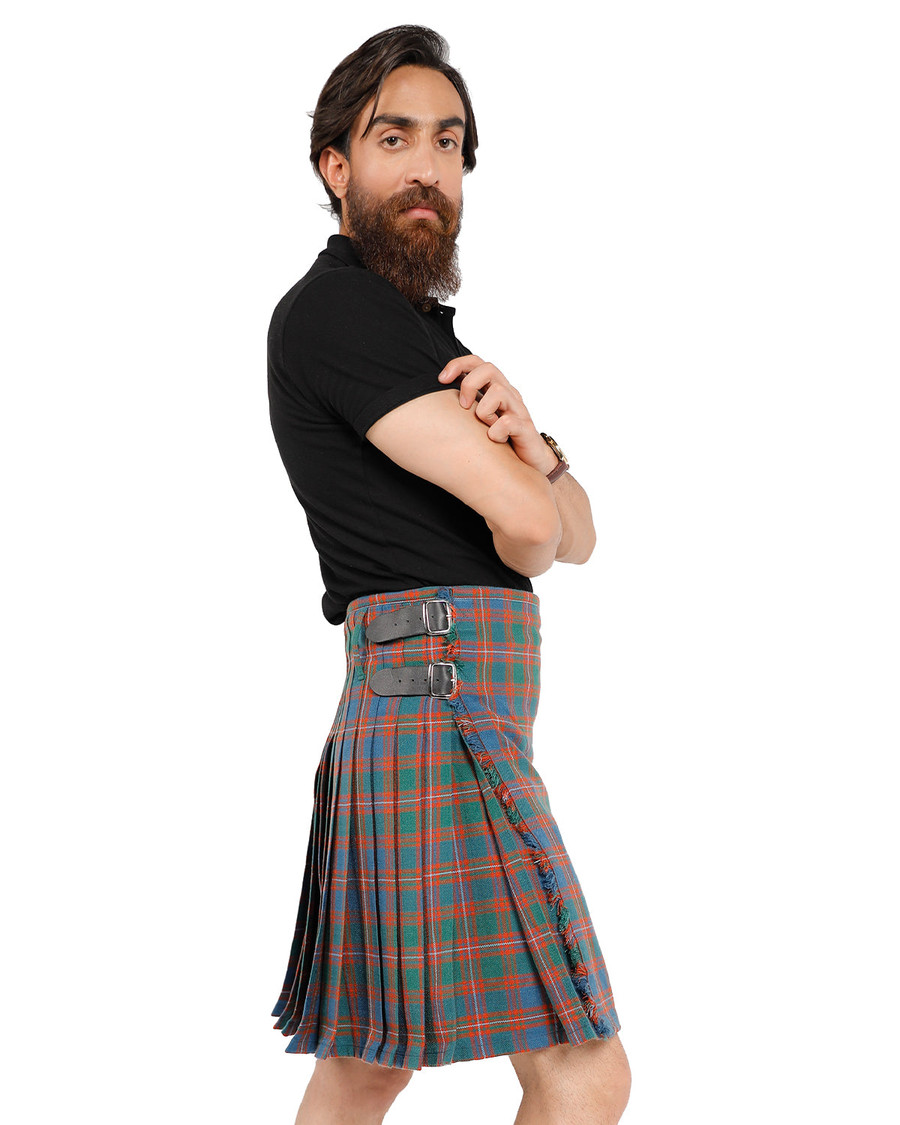 Bespoke kilt in grey, white and blue tartan with leather straps, side view on a man