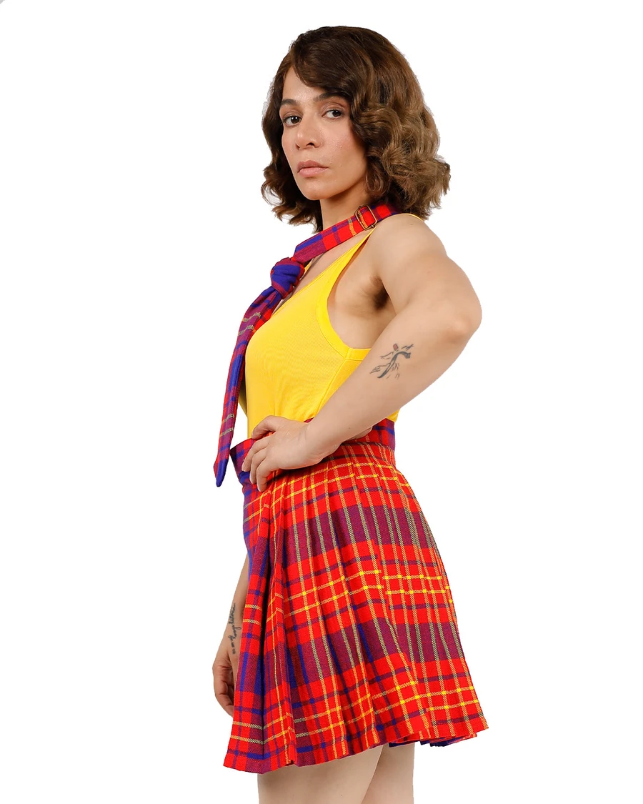 Woman in red, yellow and purple tartan flared skirt with matching neck scarf