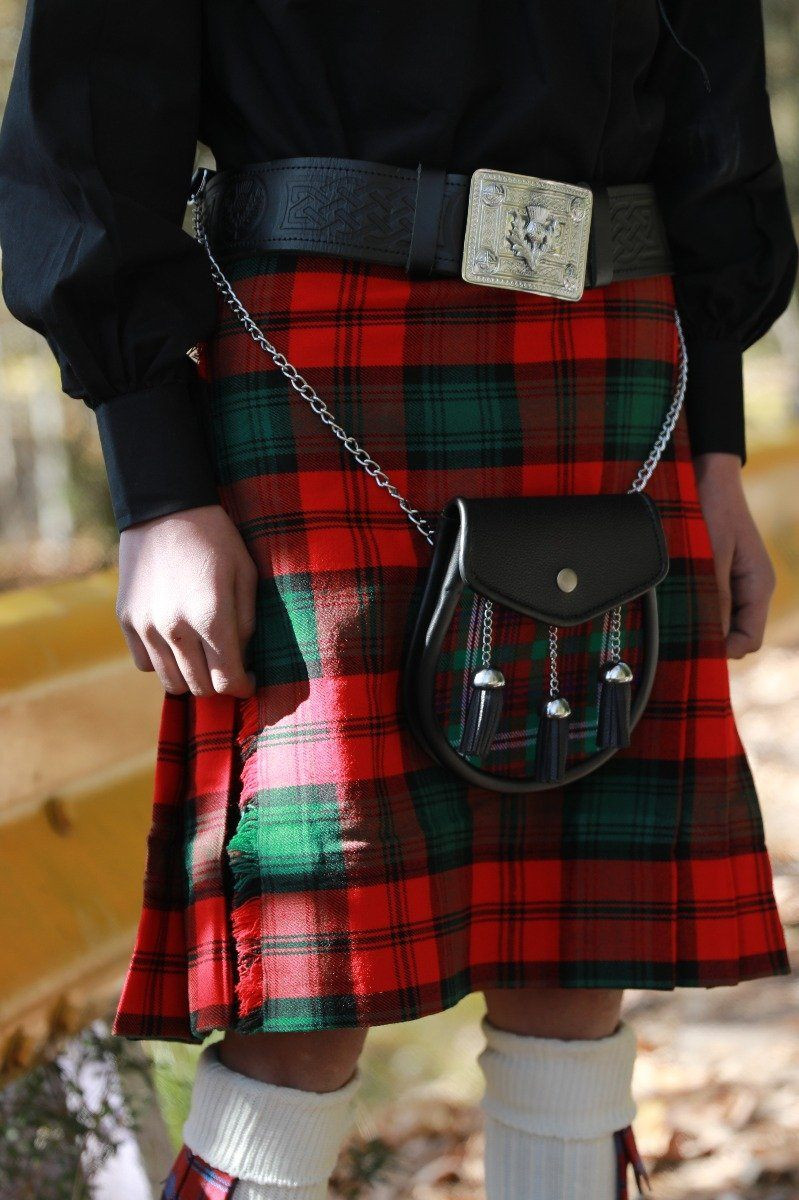 Close-up of red and green tartan kilt with leather sporran and belt buckle