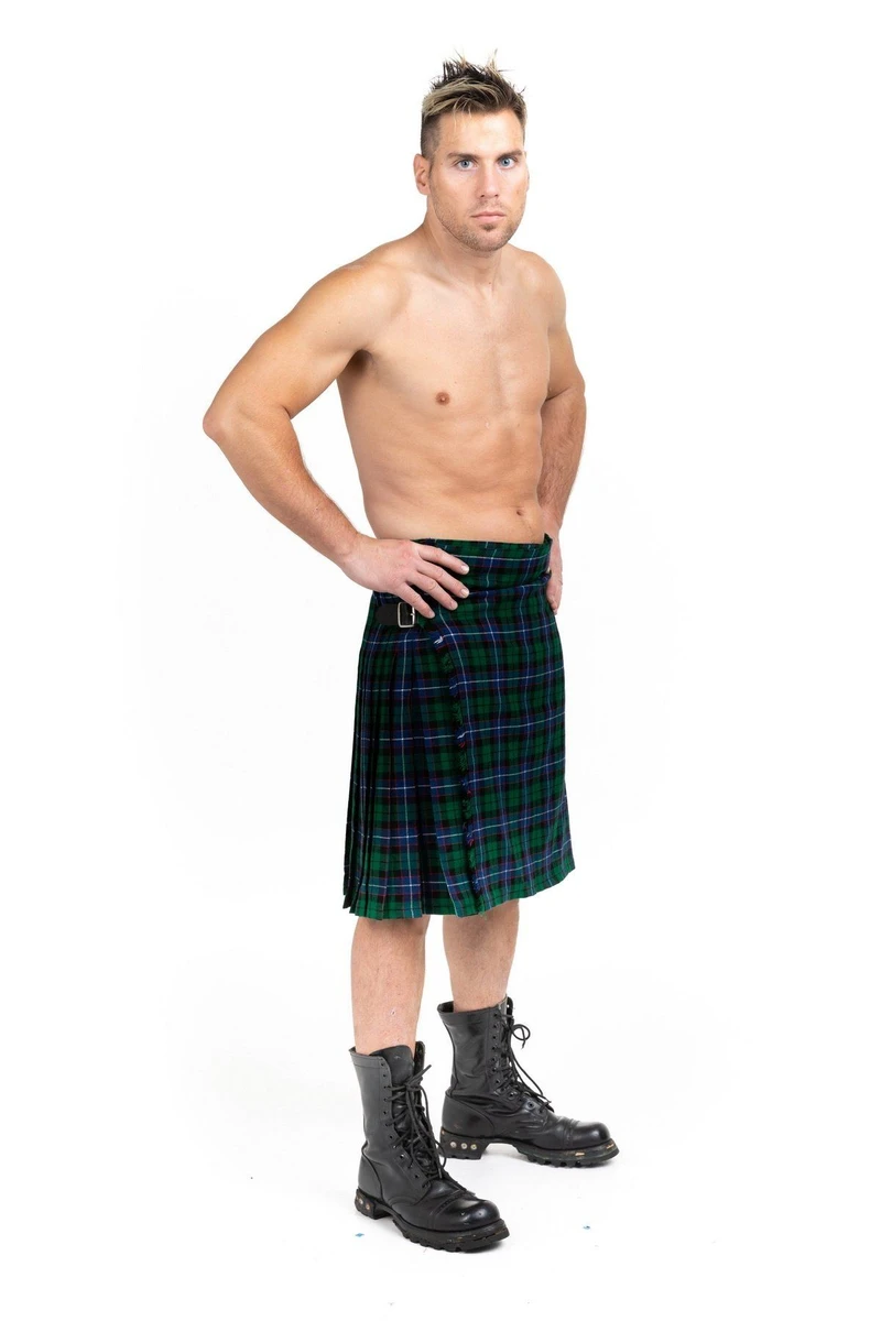Shirtless man with hand on hip in Mitchell green and navy tartan kilt with boots