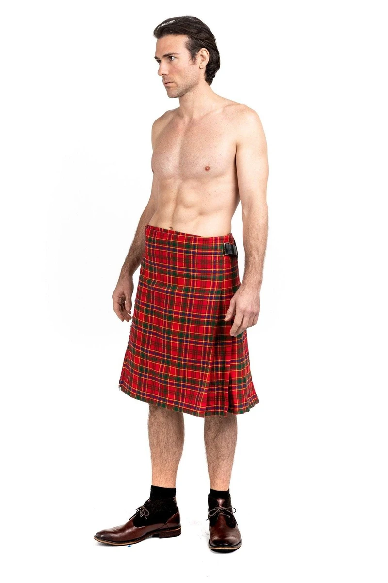 Side view of shirtless man in red Munro tartan kilt with dress shoes