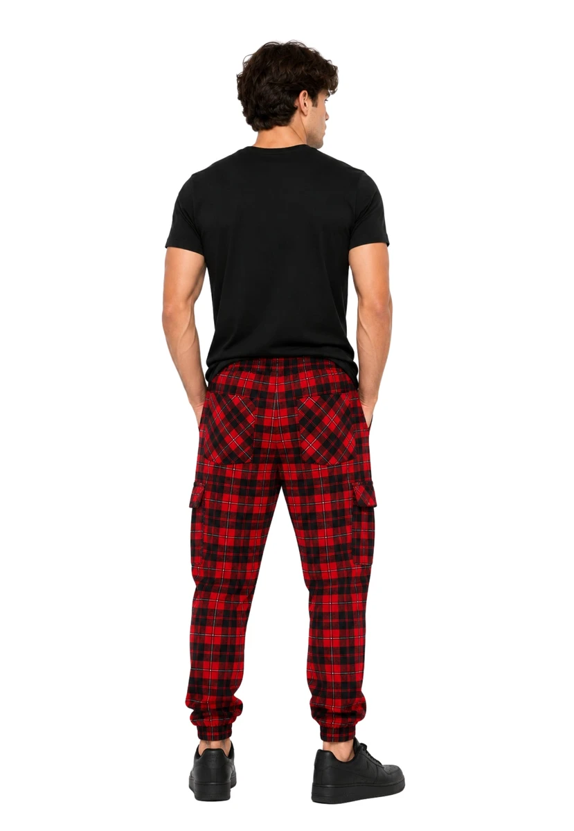 Man in navy and green tartan trousers with a green T-shirt, back view
