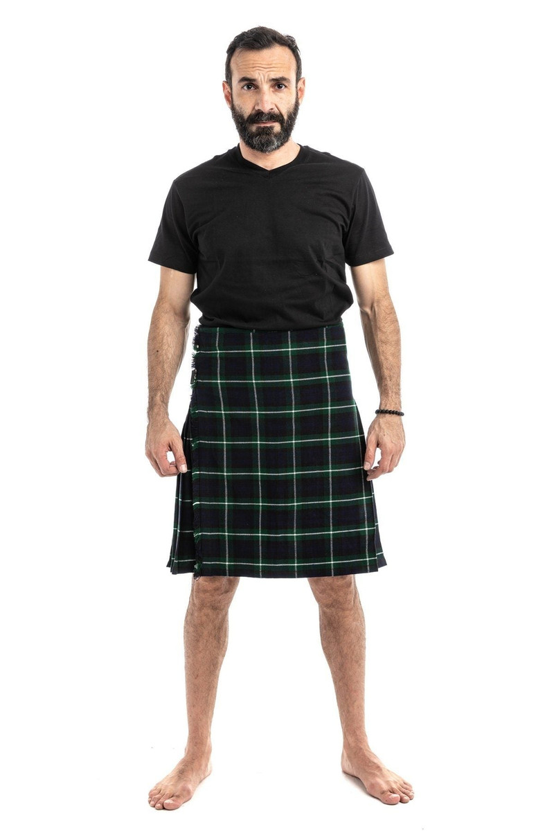 Man in navy and green tartan trousers with a green T-shirt, back view