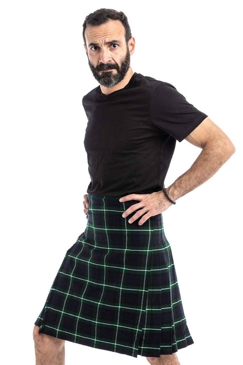 Man wearing a bespoke kilt in dark green and black tartan with white lines, side view