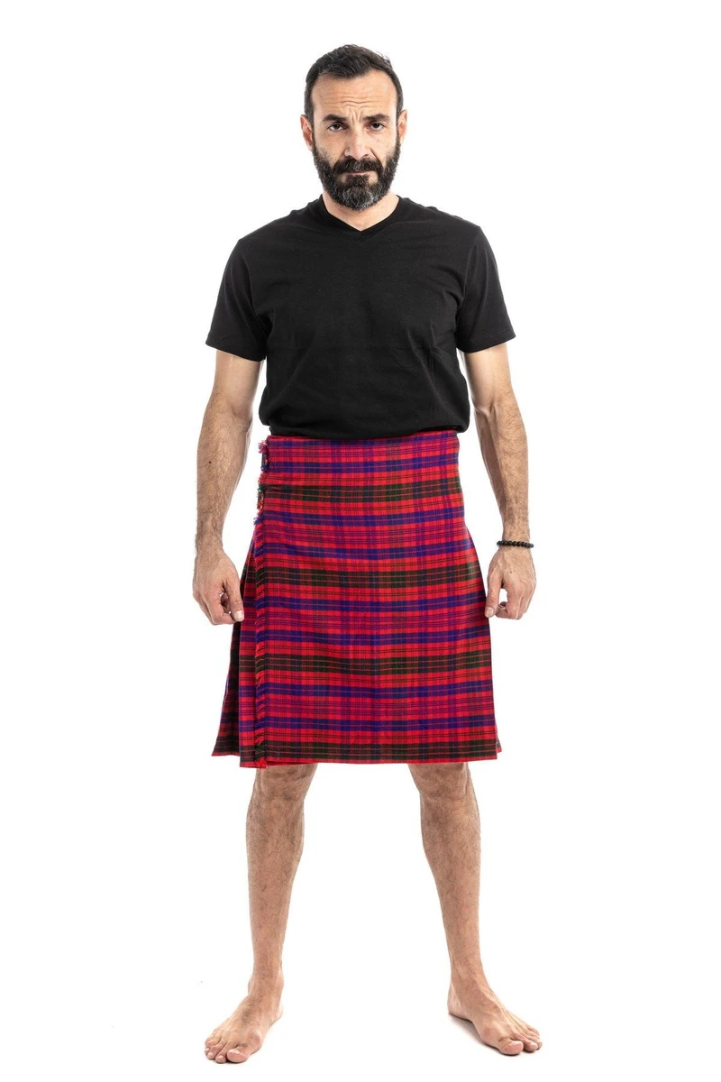 Man wearing a bespoke kilt in black and dark navy tartan with front apron pocket, front view