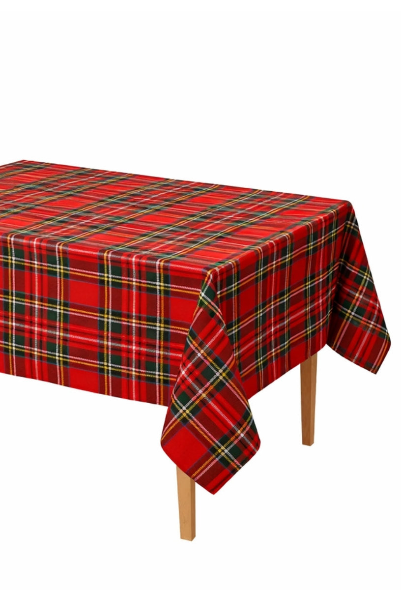 Rectangular tartan tablecloth in red, green and yellow plaid draped over a table
